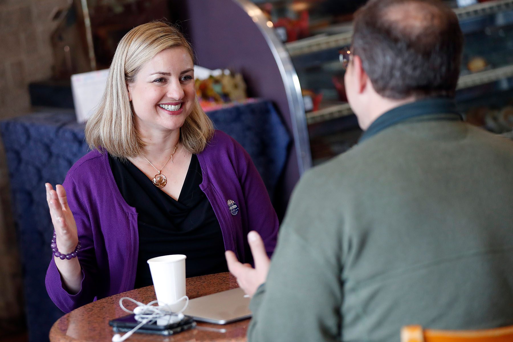 Kate Gallego speaks to a constituant at a coffee shop.