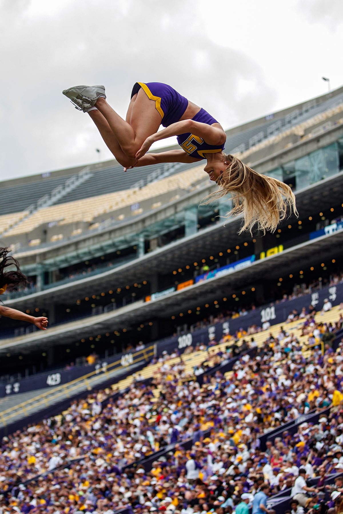 An LSU Tigers cheerleader is seen mid-air during a performance.