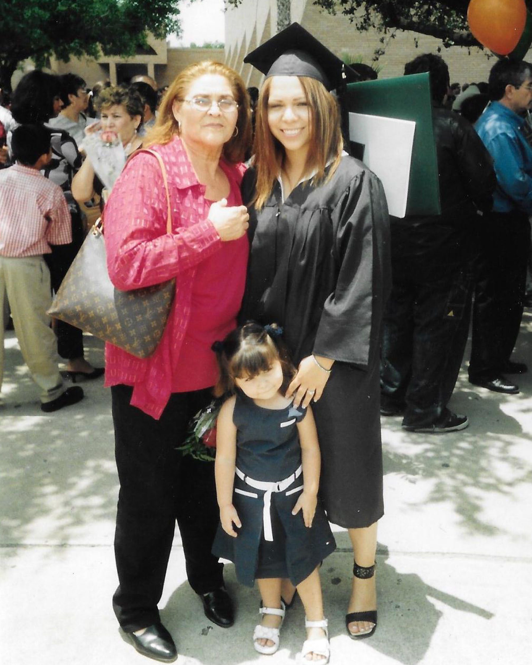 Jacqueline as a child poses with her mother and grandmother at her mother's graduation.