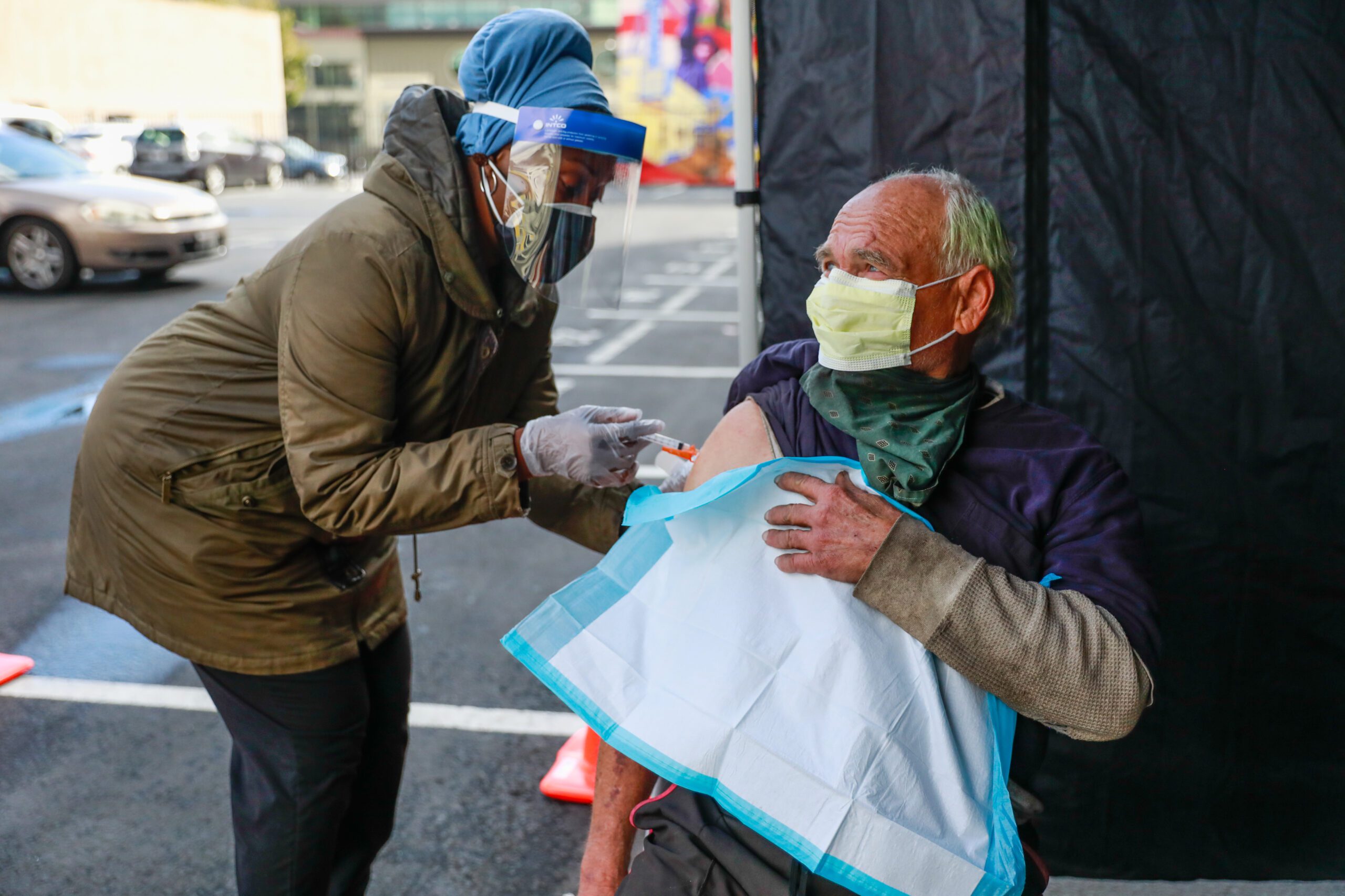 A nurse administers a COVID vaccine to an unhoused person.