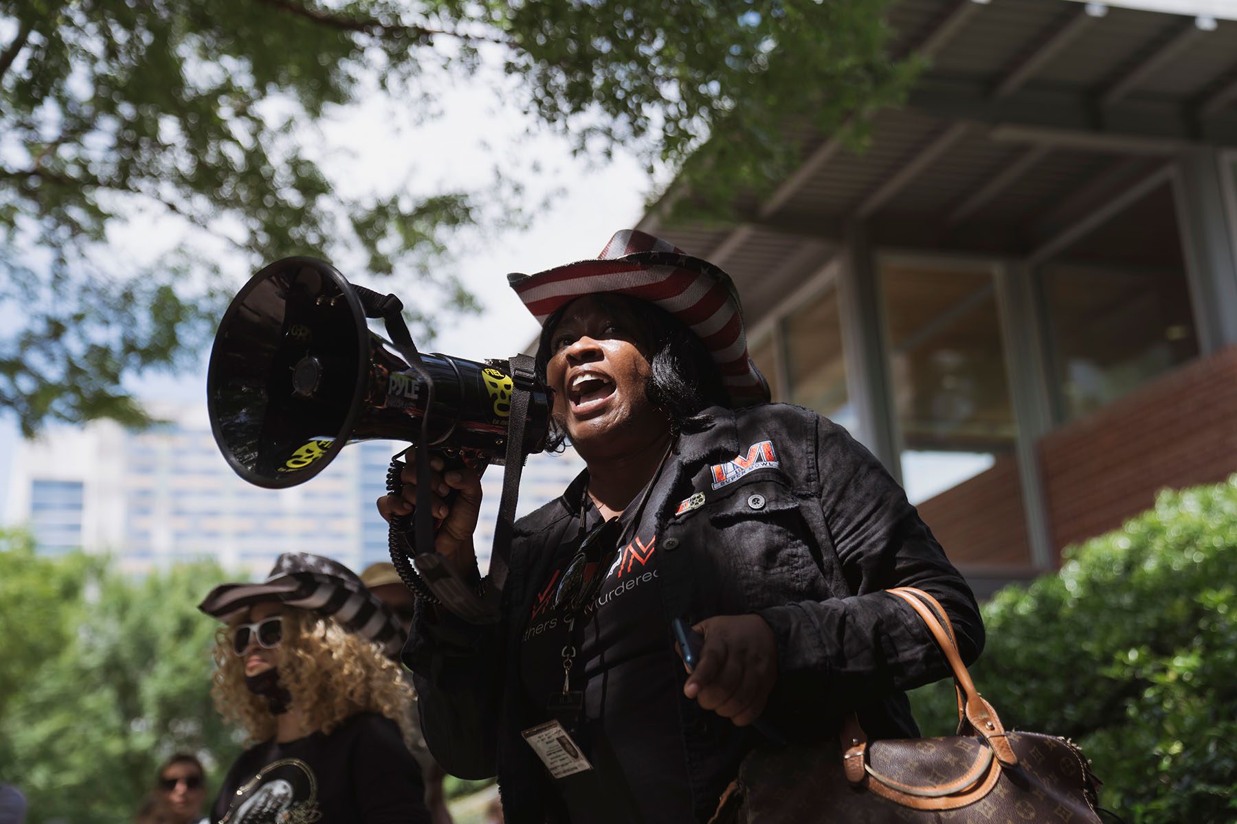 A woman yells through a megaphone during a protest.