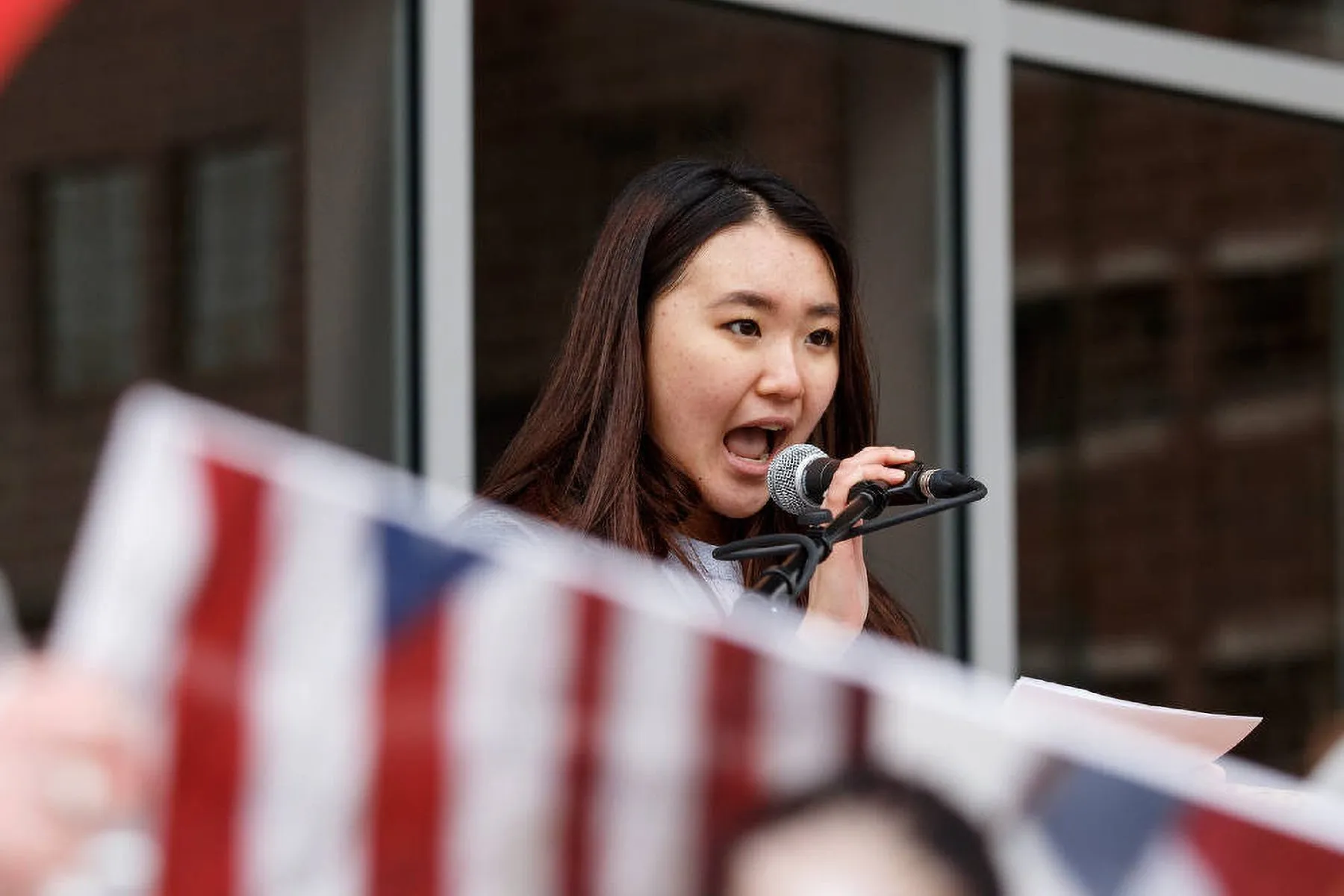 Seo Yoon Yang speaks into a microphone at a gathering.