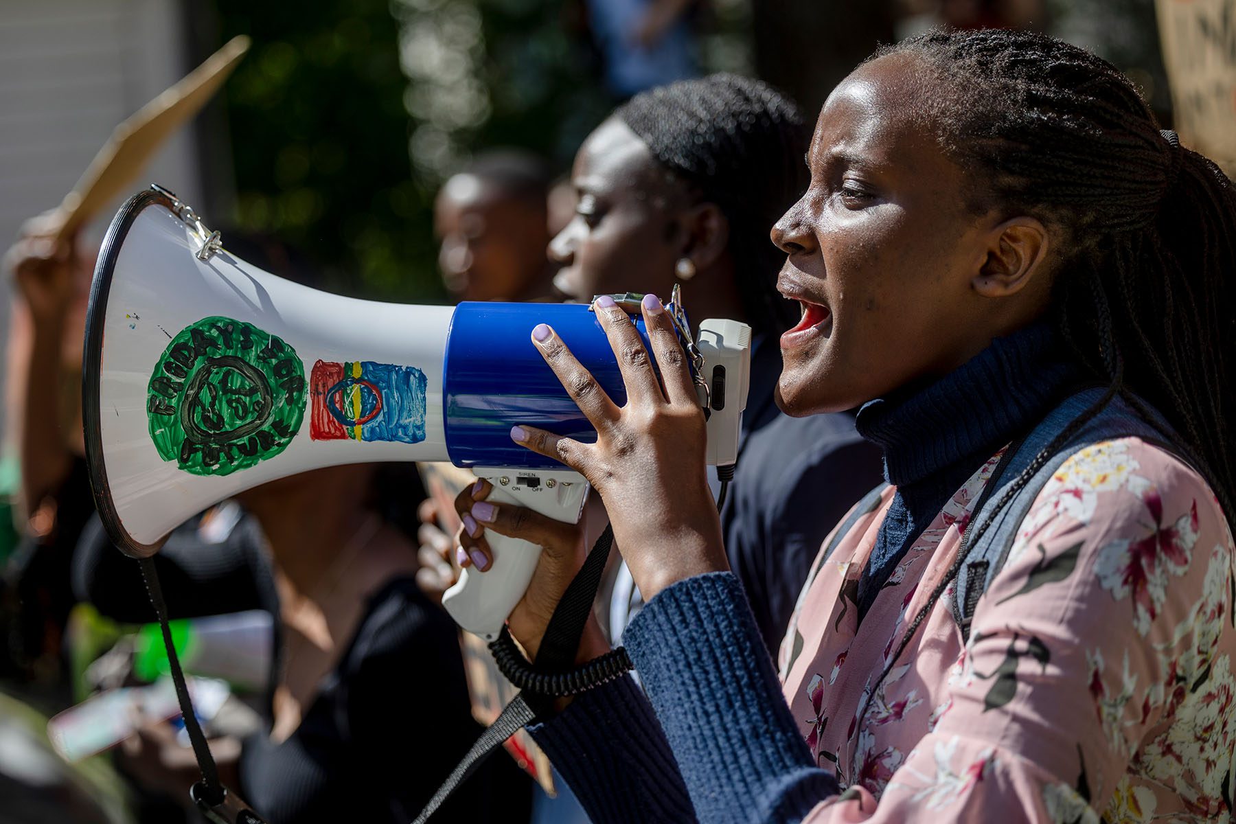 Vanessa Nakate shouts into a megaphone during a protest.