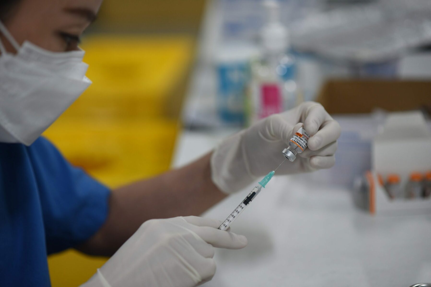 A health worker prepares covid-19 vaccine for young children