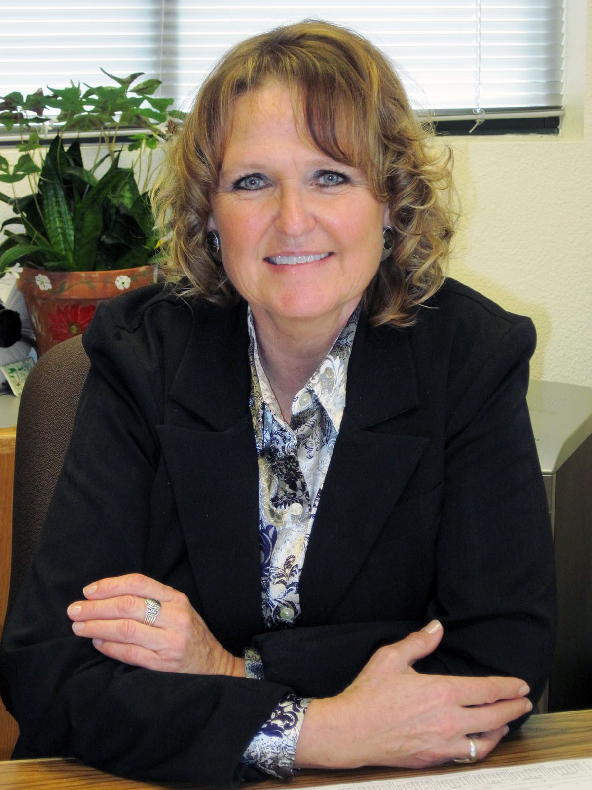 Smiling headshot of Leslie Hoffman in her office.