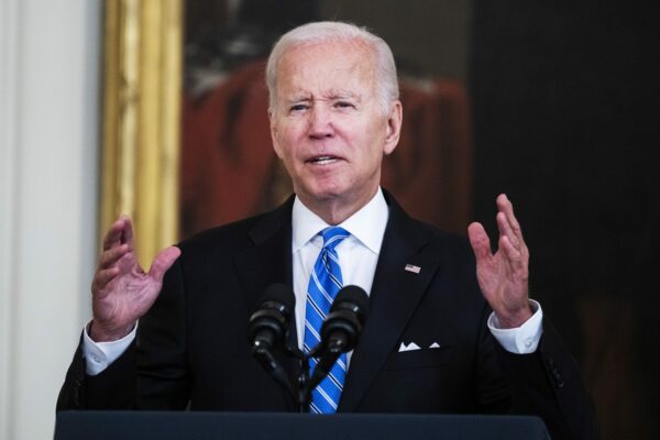 President Biden speaks in front of a microphone