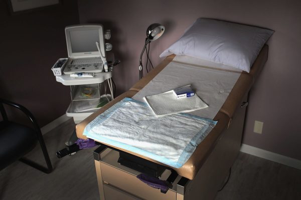 An ultrasound machine sits next to an exam table in an examination room at an Indiana abortion clinic.