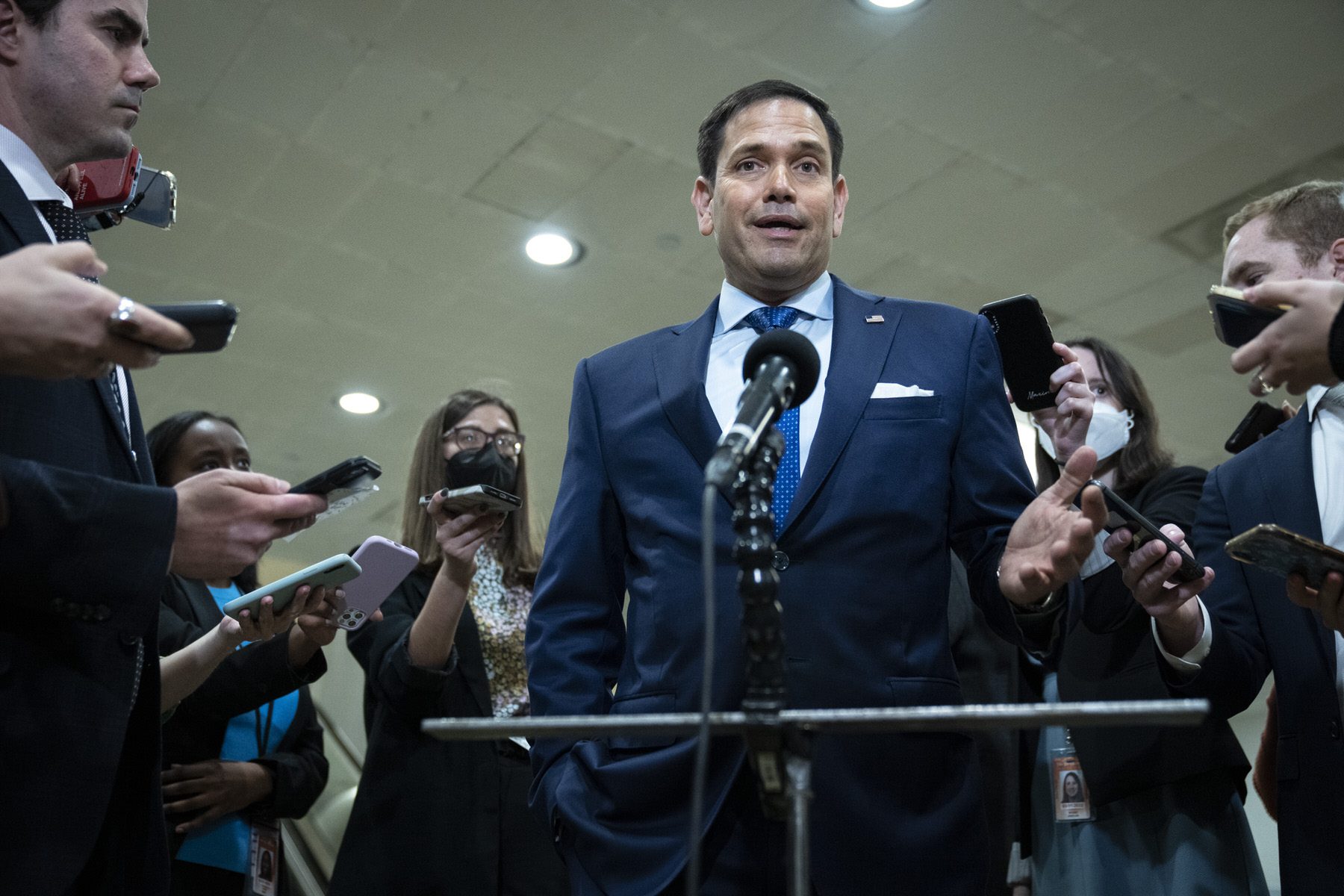 Marco Rubio speaks surrounded by reporters