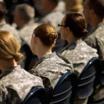 Soldiers, officers and civilian employees attend a commencement ceremony.