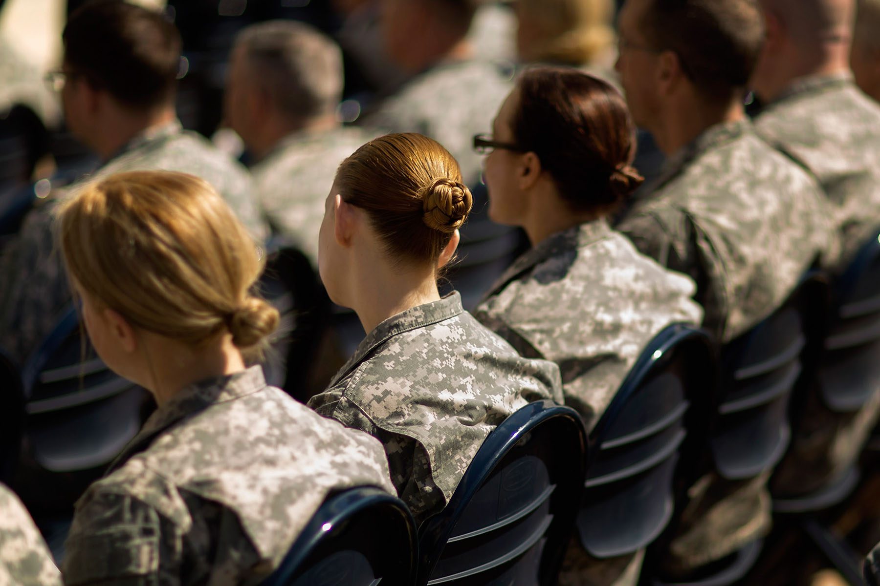 Soldiers, officers and civilian employees attend a commencement ceremony.