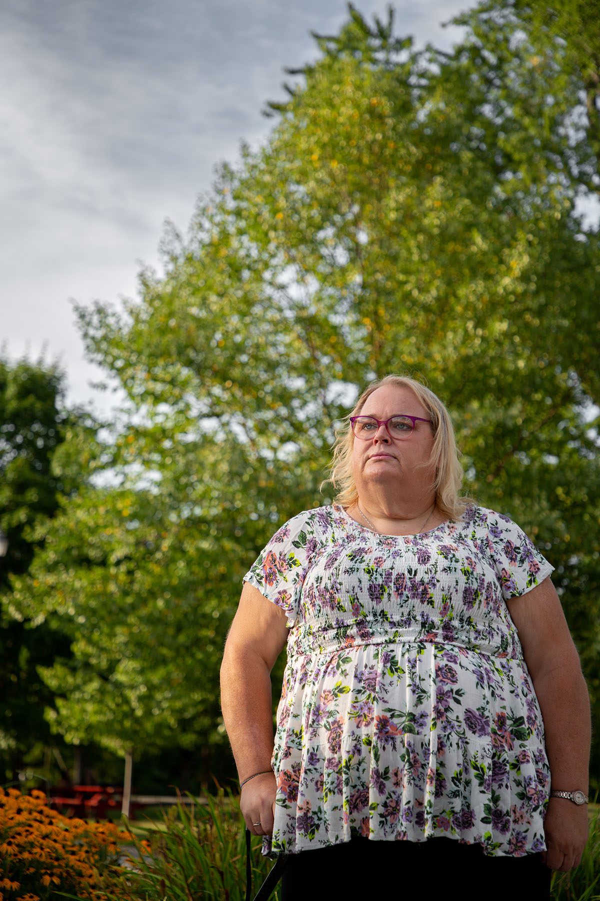 JulieAnn Fitzy poses for a portrait in a park.