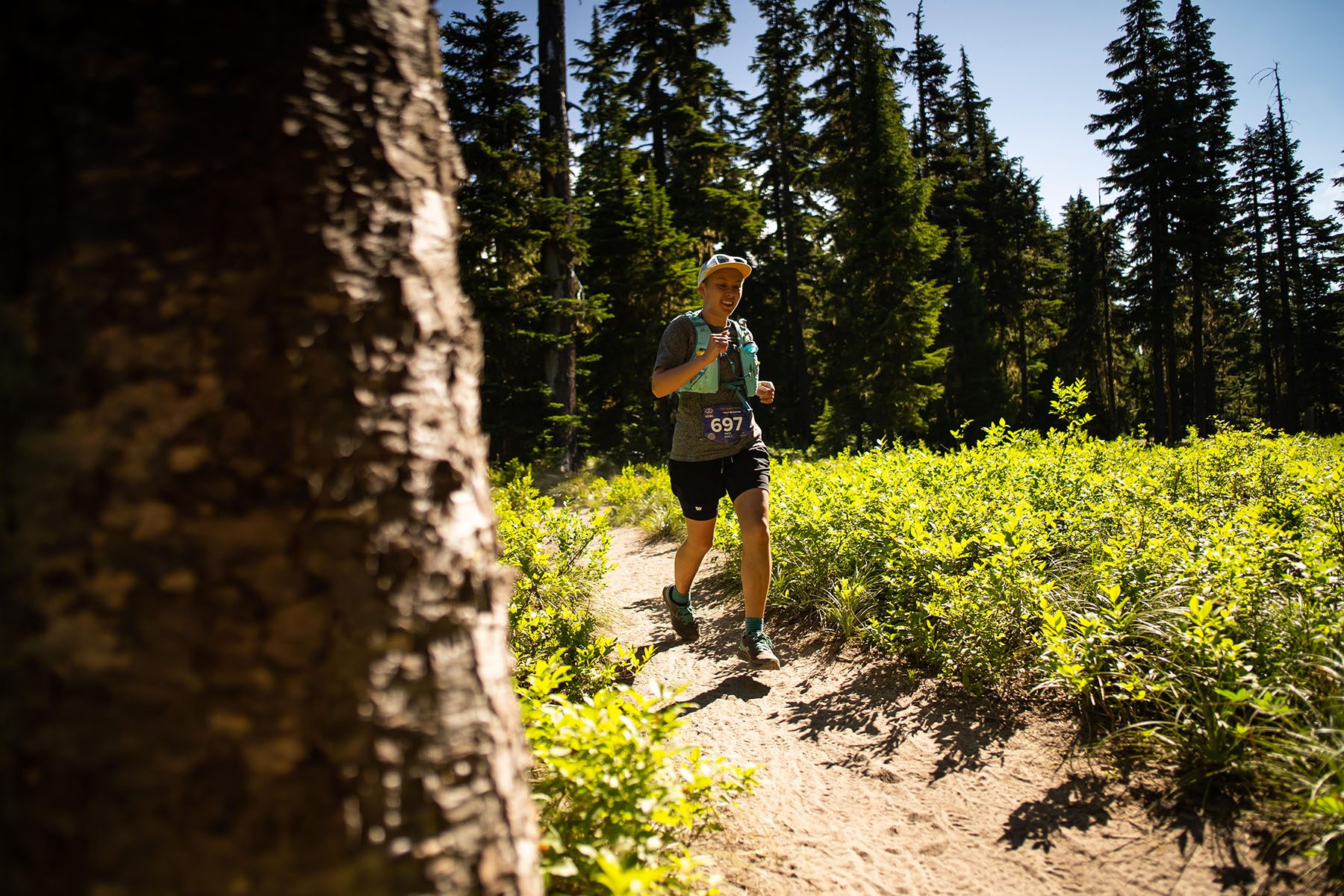 Nick Pham runs through a forest path.