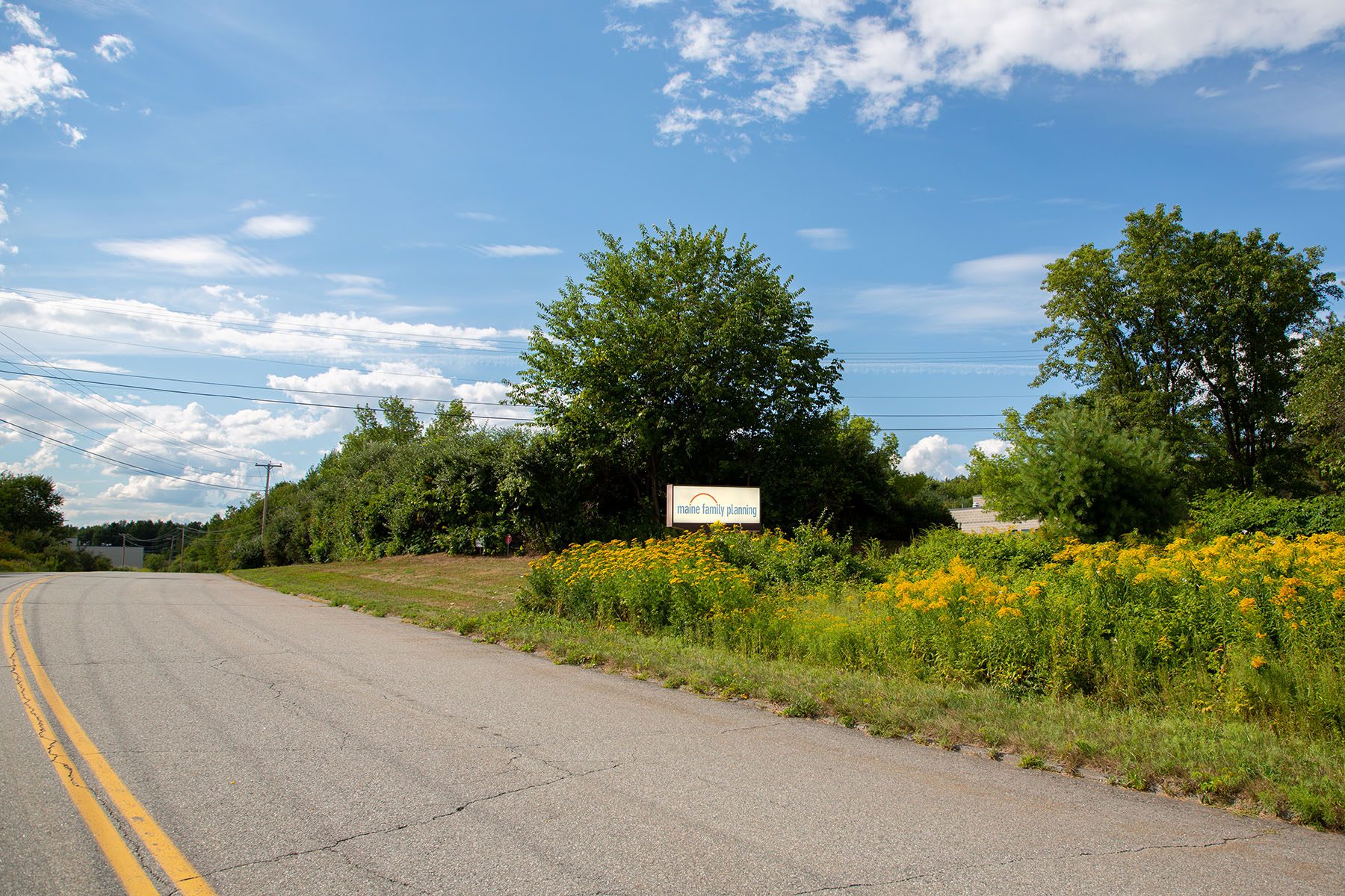 A sign for the Maine Family Clinic is seen on the side of a road.