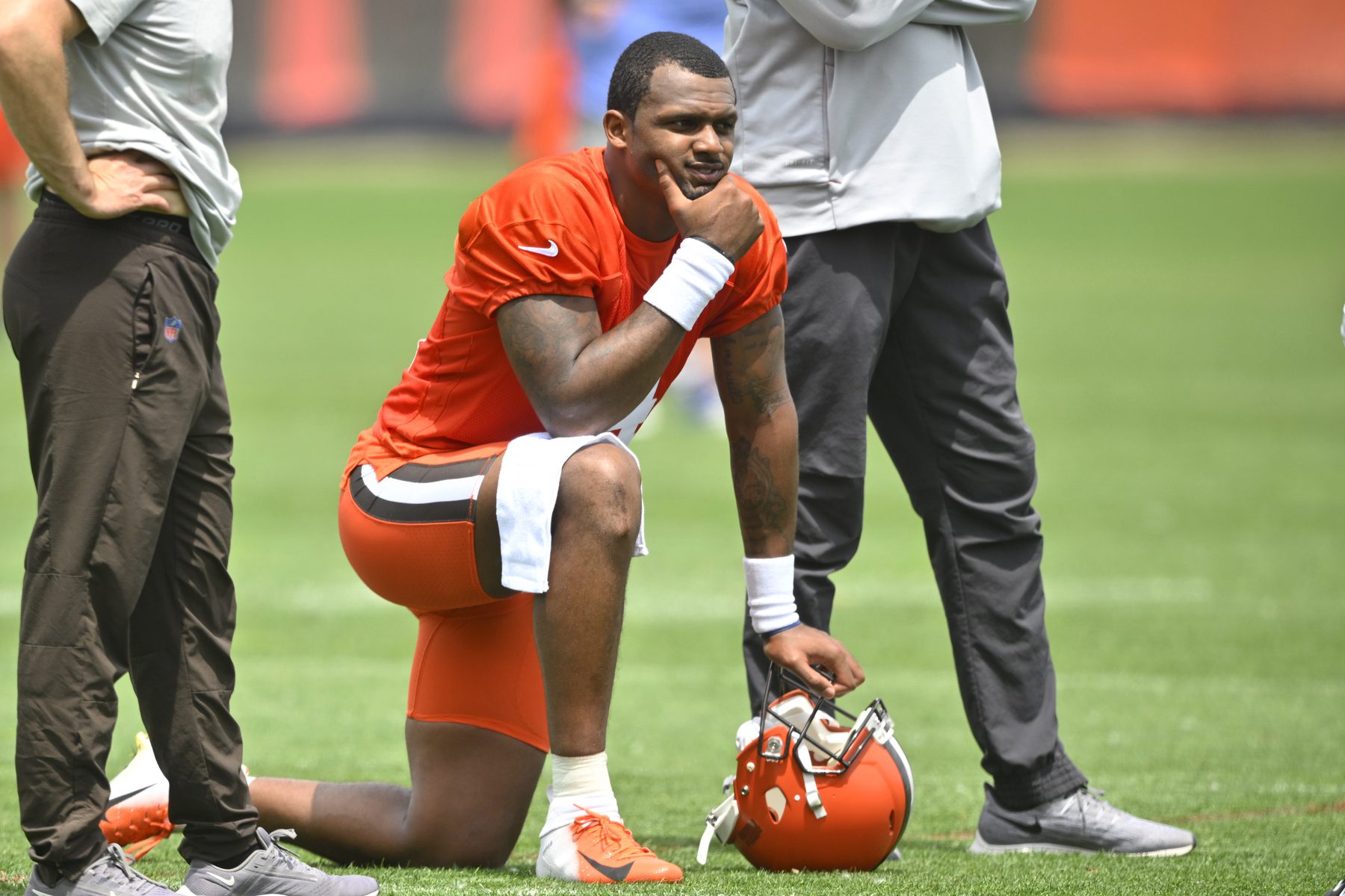 Cleveland Browns quarterback Deshaun Watson kneels on a football field.