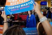 Sen. Catherine Cortez Masto attends a campaign event at a Mexican restaurant. Supporters hold campaign signs around her.