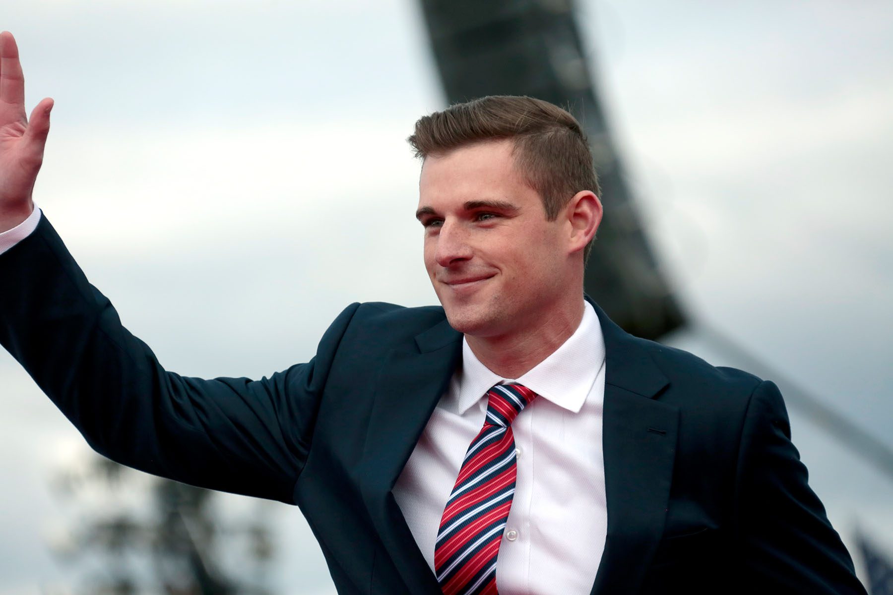 Bo Hines waves to the crowd at a rally.