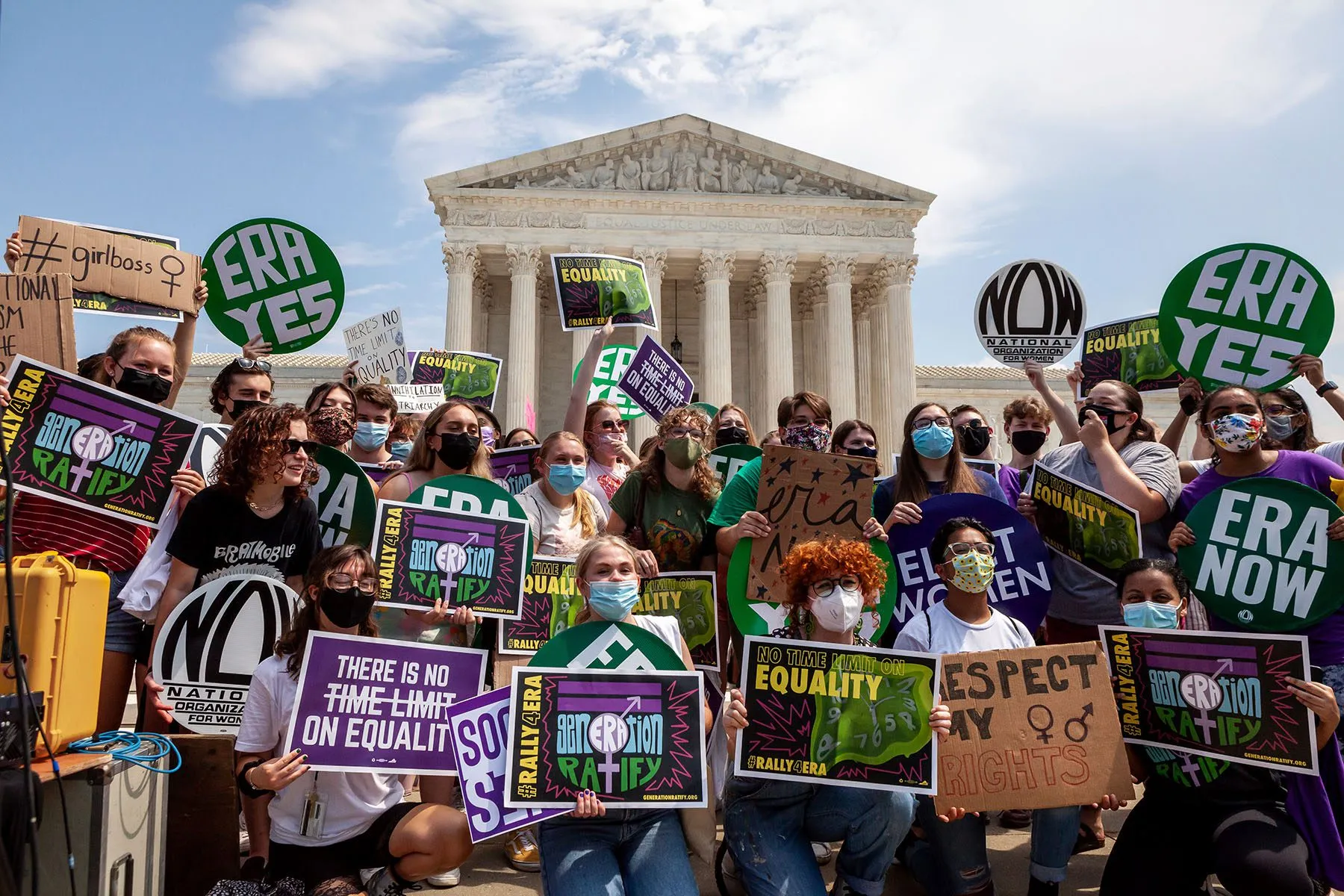 Members of Generation Ratify hold signs that read "ERA YES" and "No time limit on equality" in front of the Supreme Court.