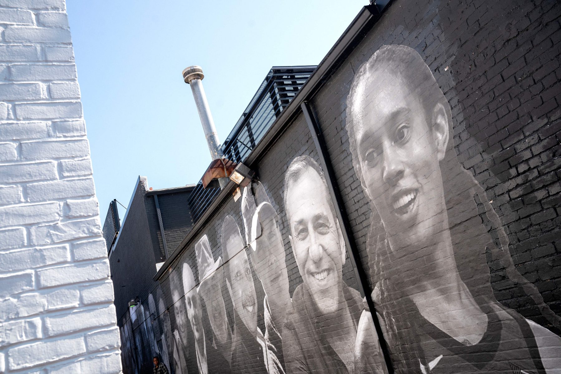 black and white mural by Isaac Campbell in Washington D.C. of Americans held overseas, including WNBA star Brittney Griner