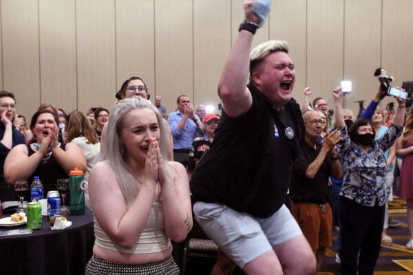 Abortion rights supporters react by jumping and crying to the failed constitutional amendment proposal a watch party.