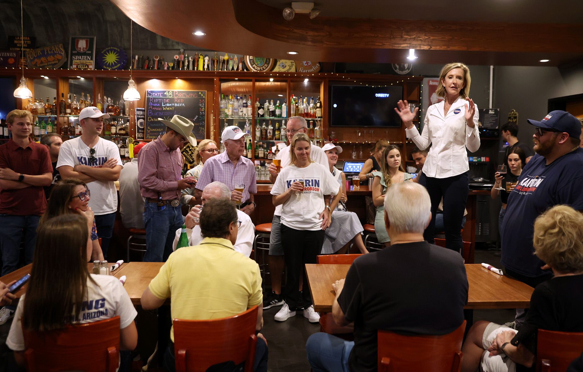 Karrin Taylor Robson stands in a restaurant and speaks