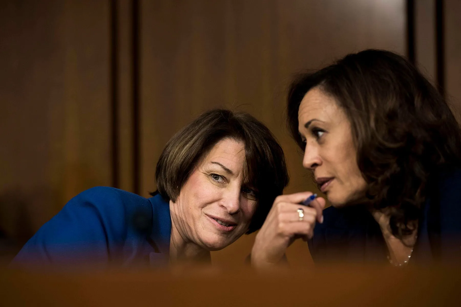 Amy Klobuchar and Kamala Harris speak quietly to each other during the Kavanaugh hearings.