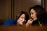 Amy Klobuchar and Kamala Harris speak quietly to each other during the Kavanaugh hearings.