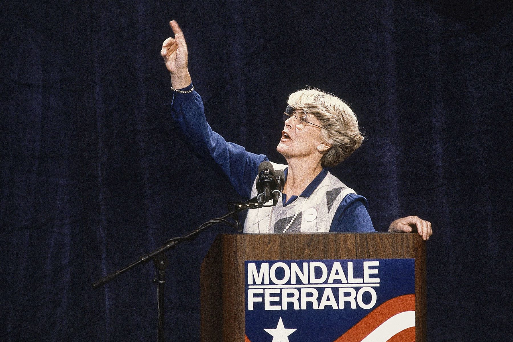 Geraldine Ferraro gives a speech on a podium during the Mondale Ferraro presidential campaign.
