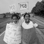 Two young girls wear protest signs that read 