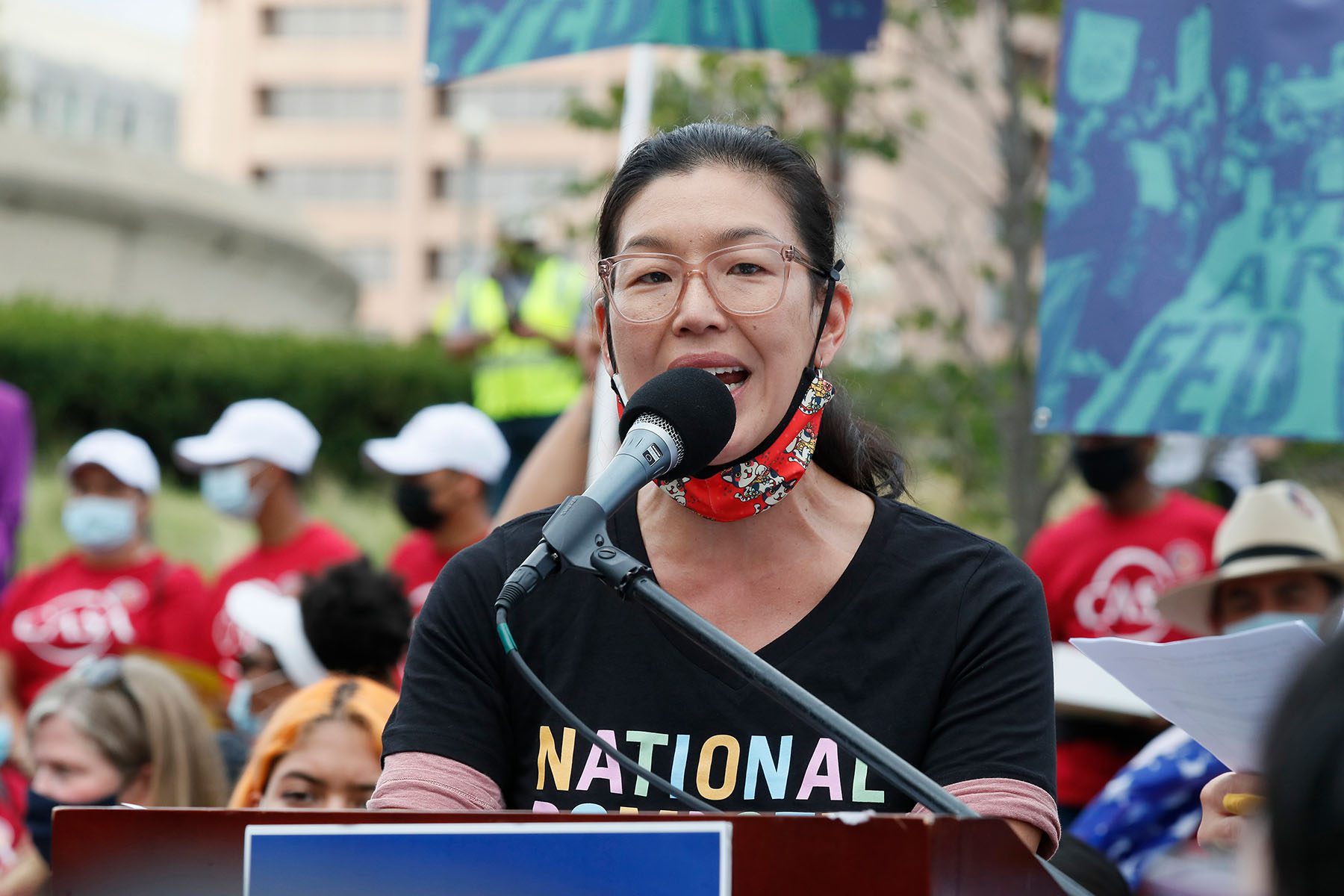 Ai-jen Poo speaks at a rally.