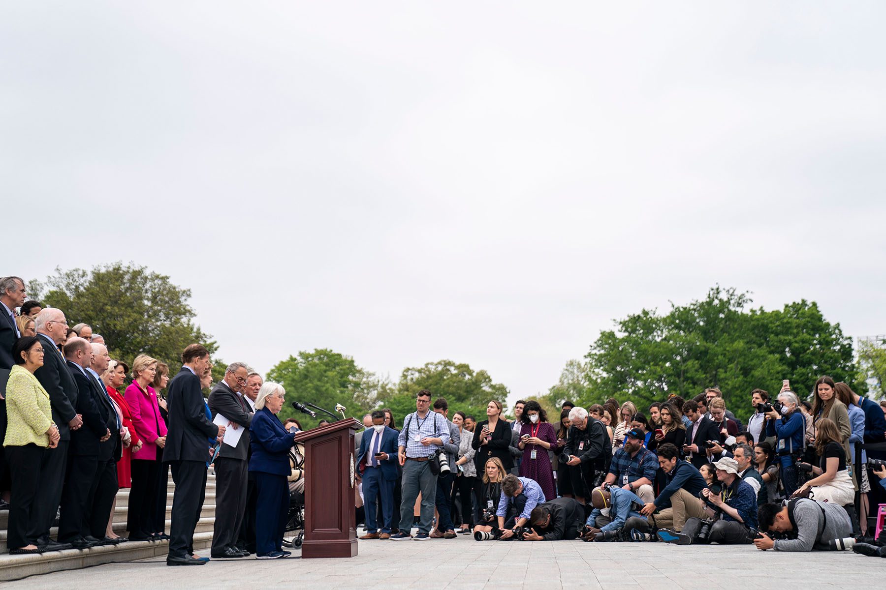 Members of the media are seen as Sen. Patty Murray speaks as other Senate Democrats listen during a news conference.