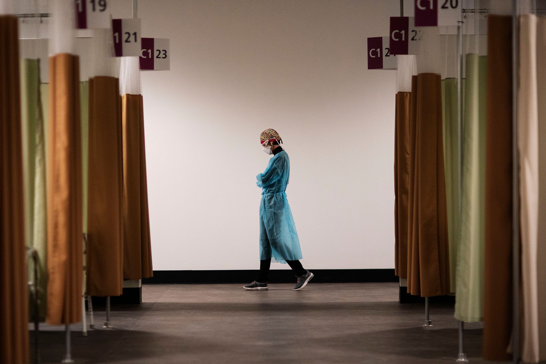 A traveling nurse walks the hallways during a night shift at a field hospital.