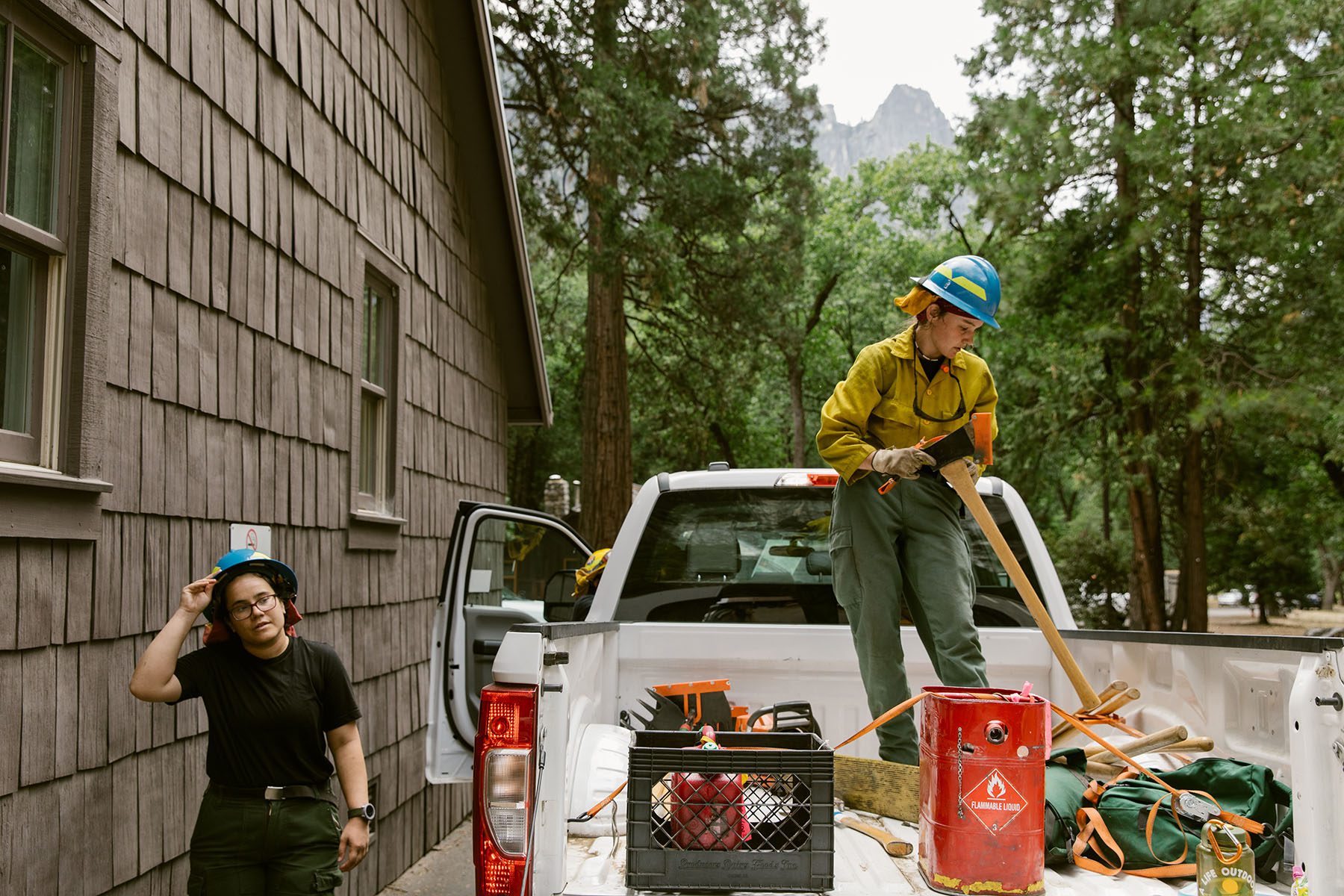 Cheyenne Haffner stands on top of a truck bed as she stores tools.