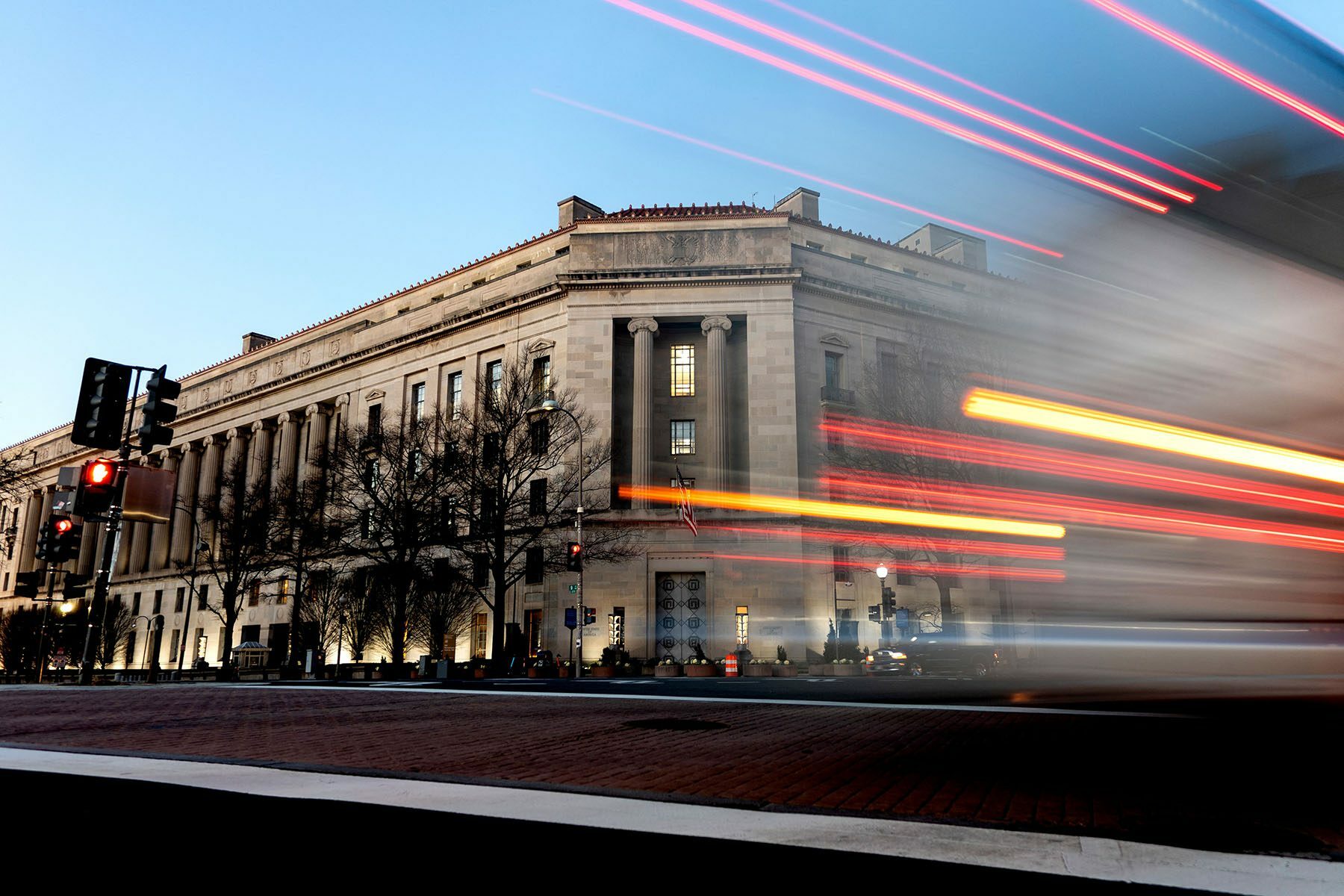A vehicle drives past the Department of Justice building in Washington, D.C.