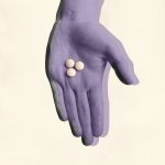 Photo illustration showing a hand holding Mifepristone pills.