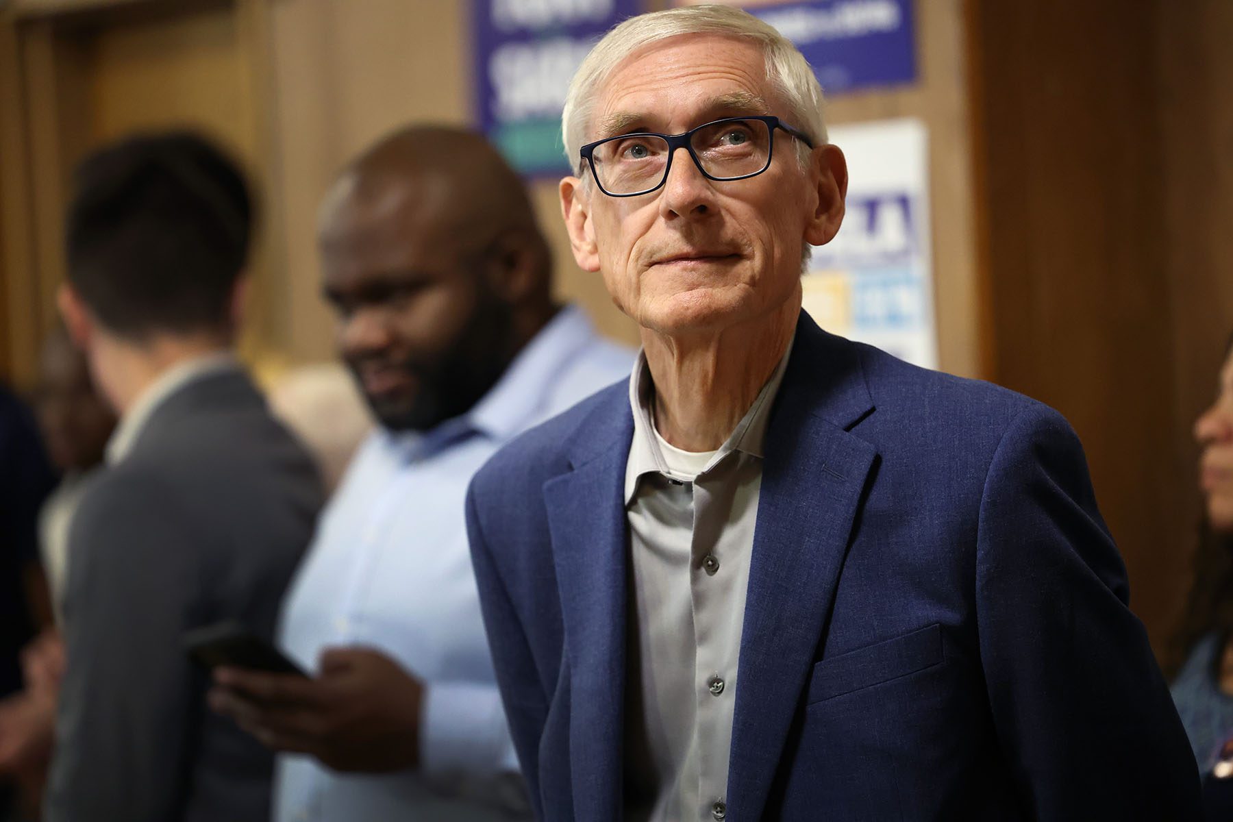 Tony Evers waits to be introduced during a campaign.