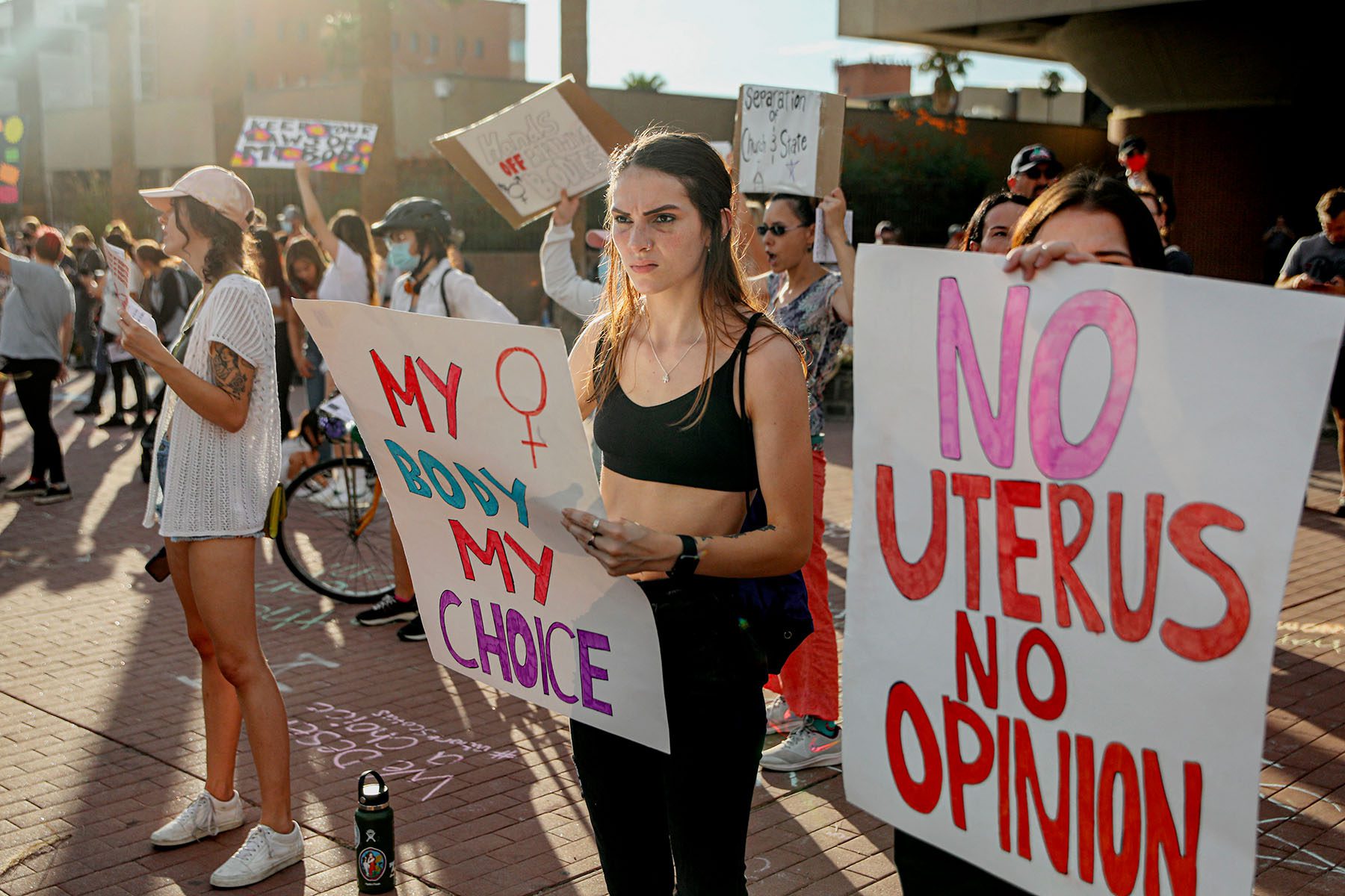 Abortion rights protesters hold signs that read "my body my choice" and "no uterus no opinion" during a demonstration near the Tuscon Federal Courthouse.