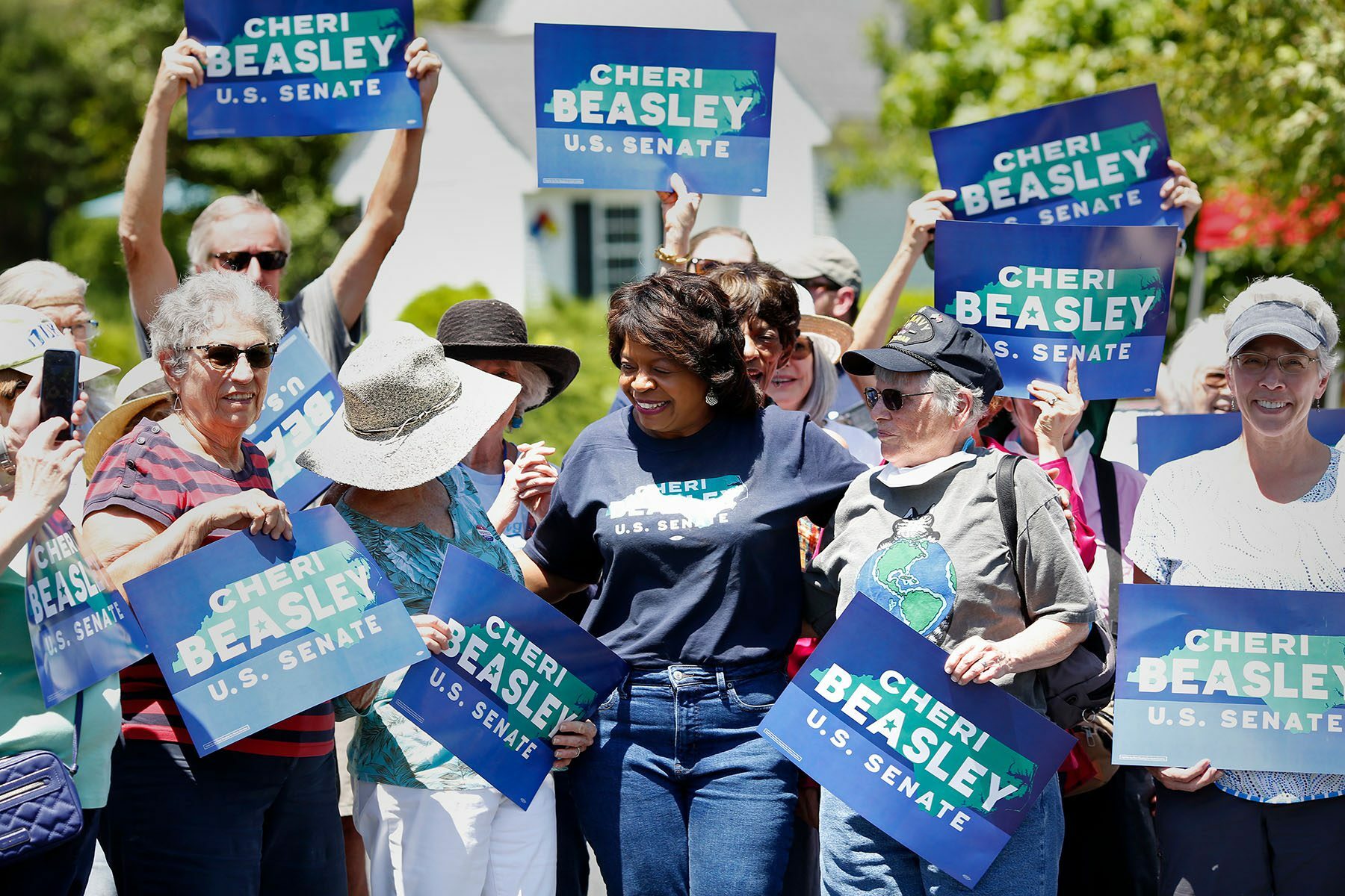 Cheri Beasley laughs after posing for a photograph with voters holding 