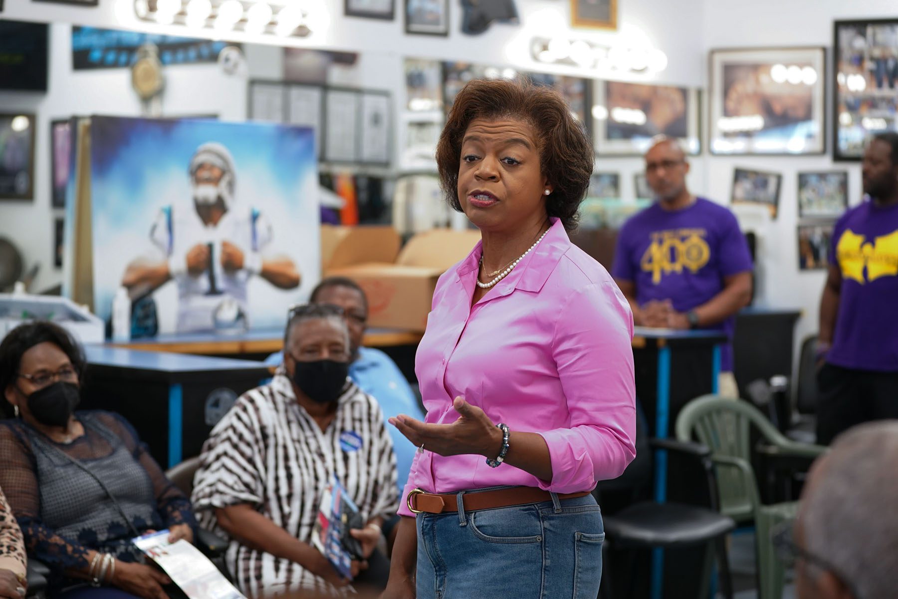 Cheri Beasley speaks with potential voters at a barbershop.