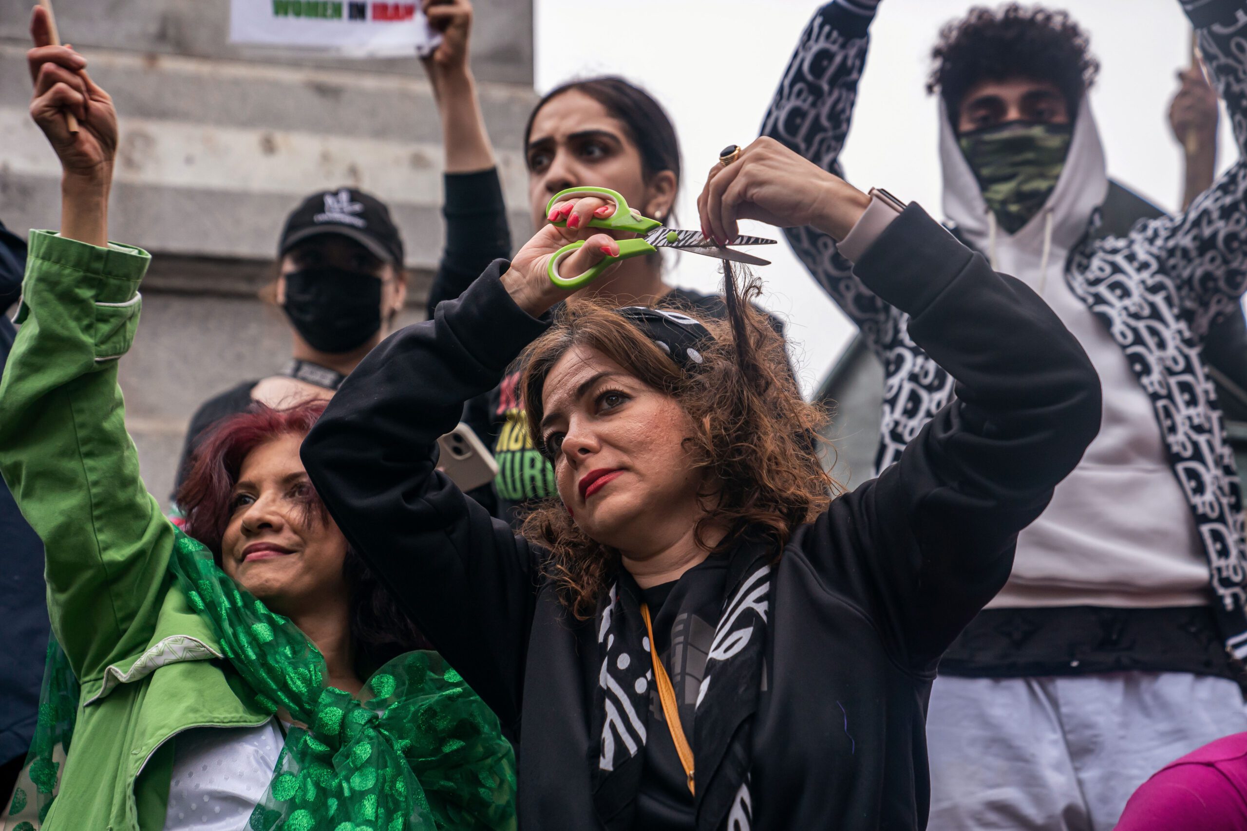 Protesters cut their hair in protest during a demonstrations in Washington, D.C.