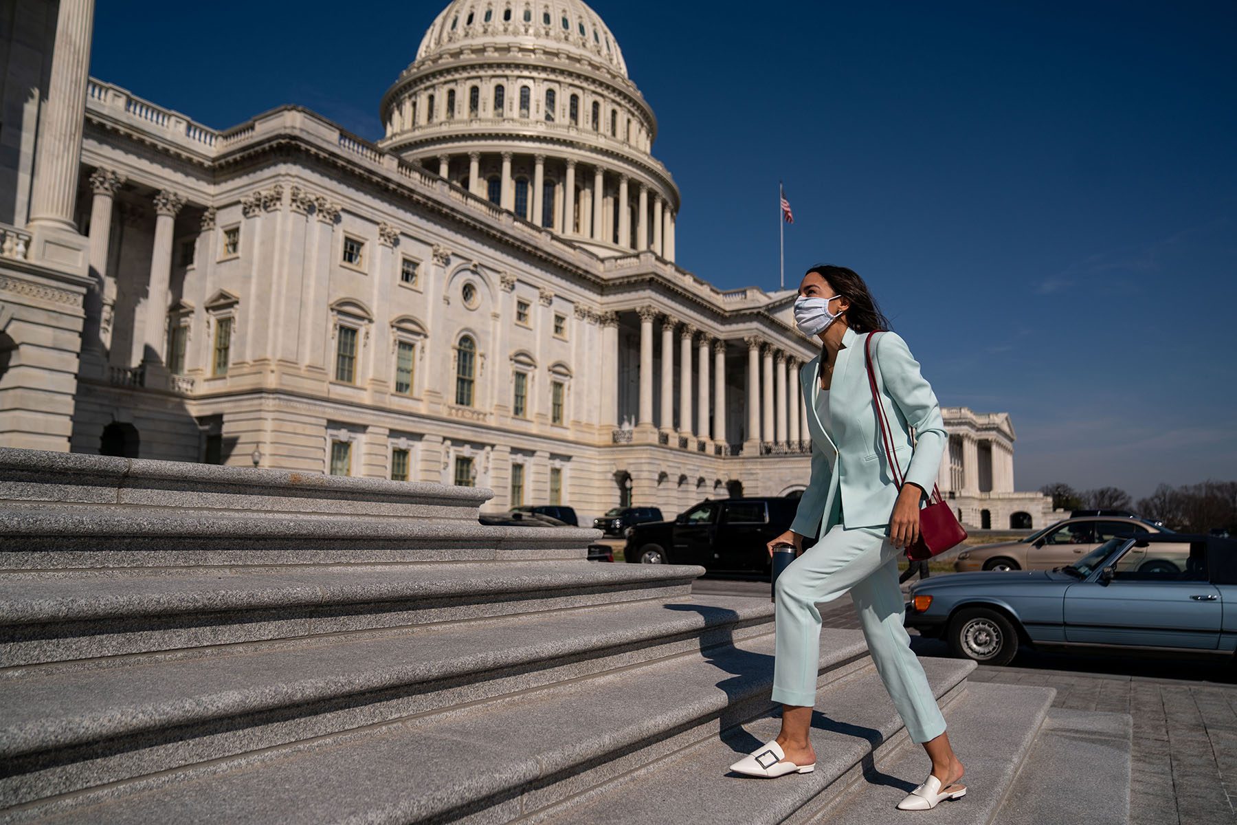 Alexandria Ocasio-Cortez walks up the steps to the House on Capitol Hill.