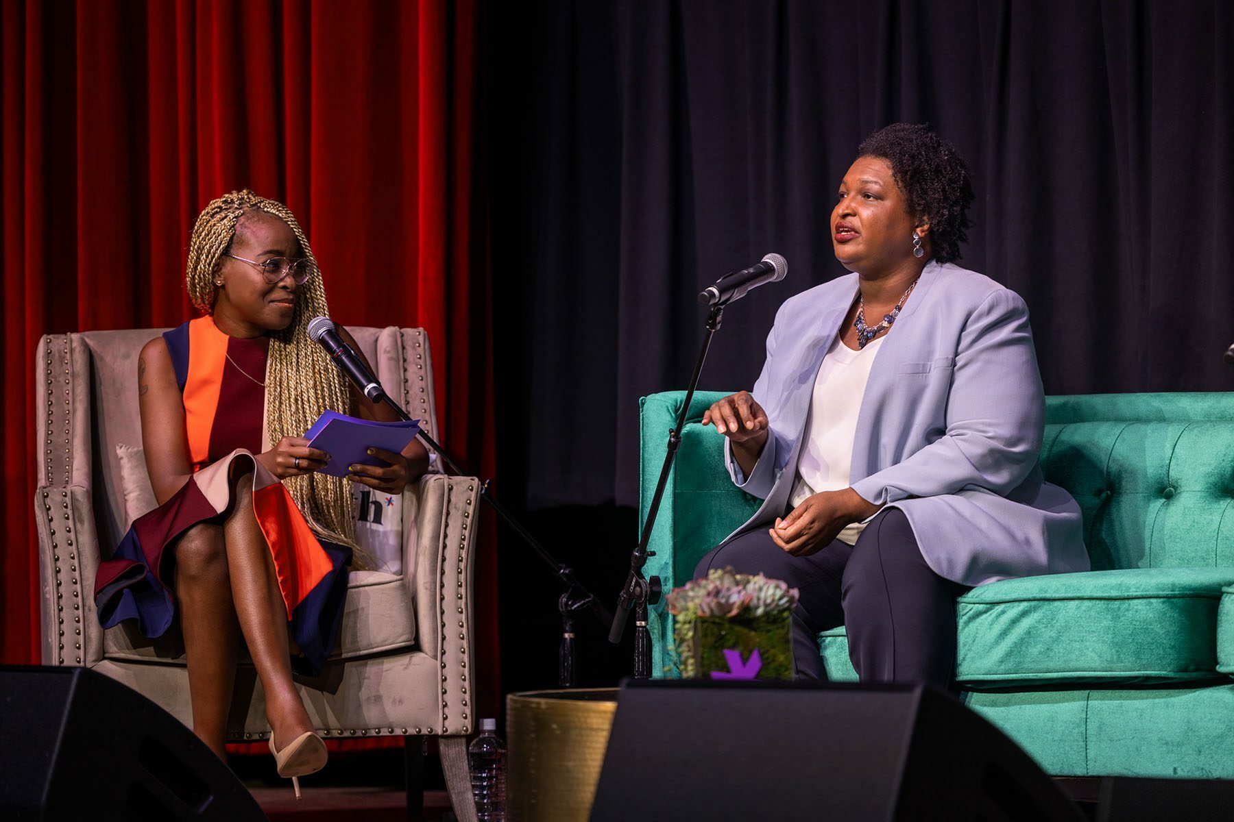 Stacey Abrams speaks to journalist Errin Haines on stage during a 19th event in Atlanta.