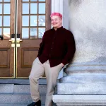 James Roesener poses for a portrait on the steps of the New Hampshire State House.
