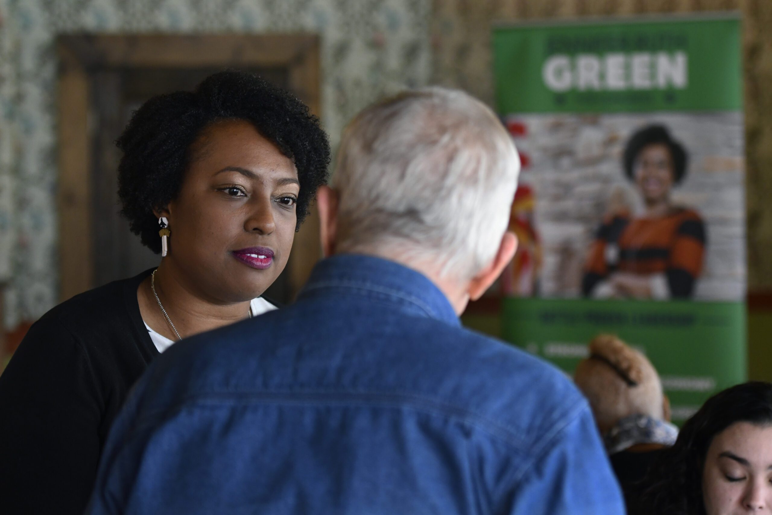 Jennifer-Ruth Green speaks with a supporter before a roundtable meeting.