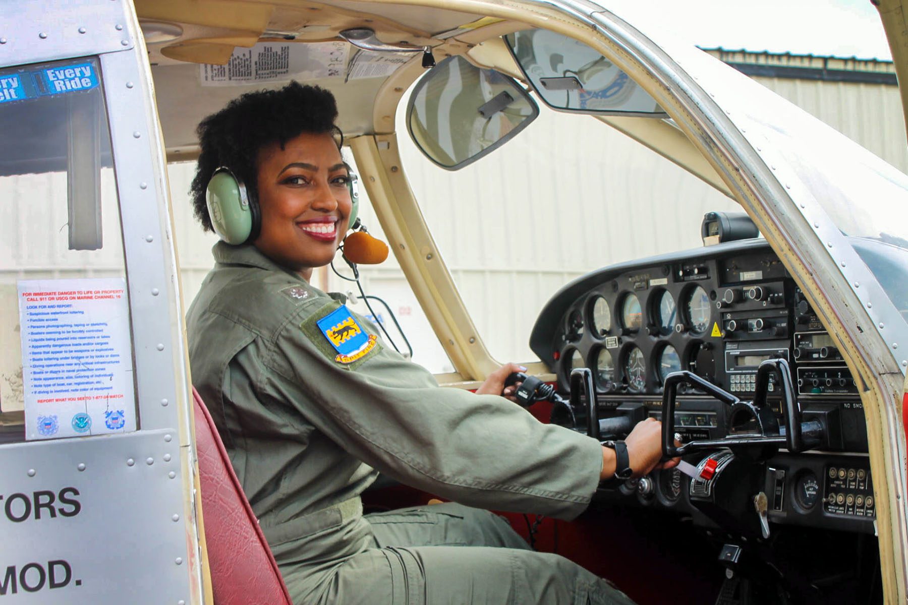 Jennifer-Ruth Green smiles while posing inside of an airplane.