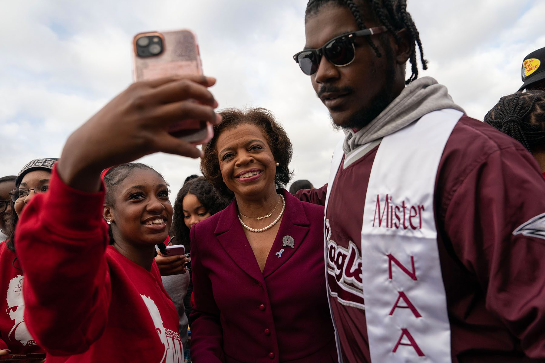 Cheri Beasley takes a selfie with two supporters while walking in the North Carolina Central University Homecoming Parade.