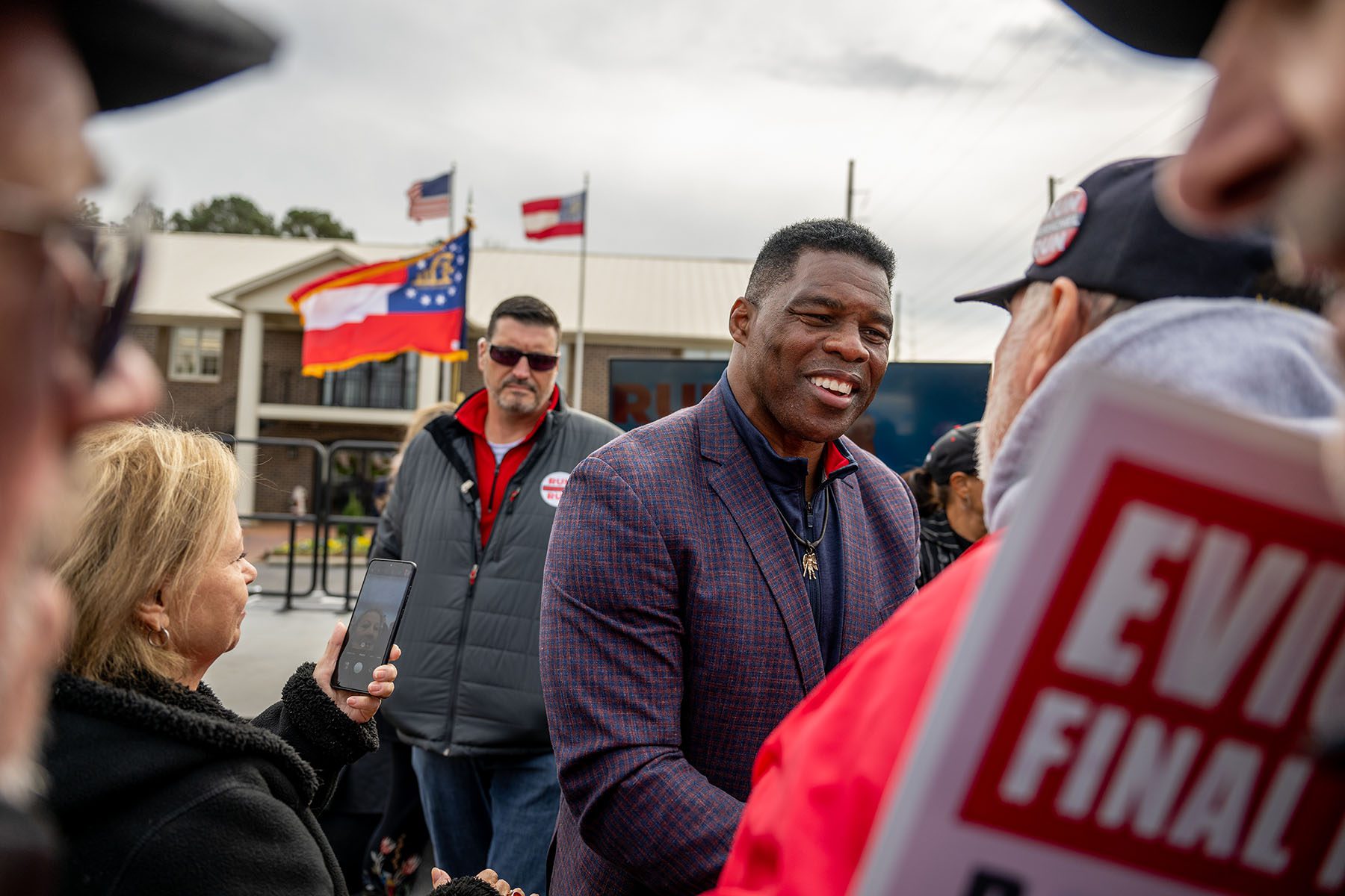 Herschel Walker greets supporters at the conclusion of a campaign rally.