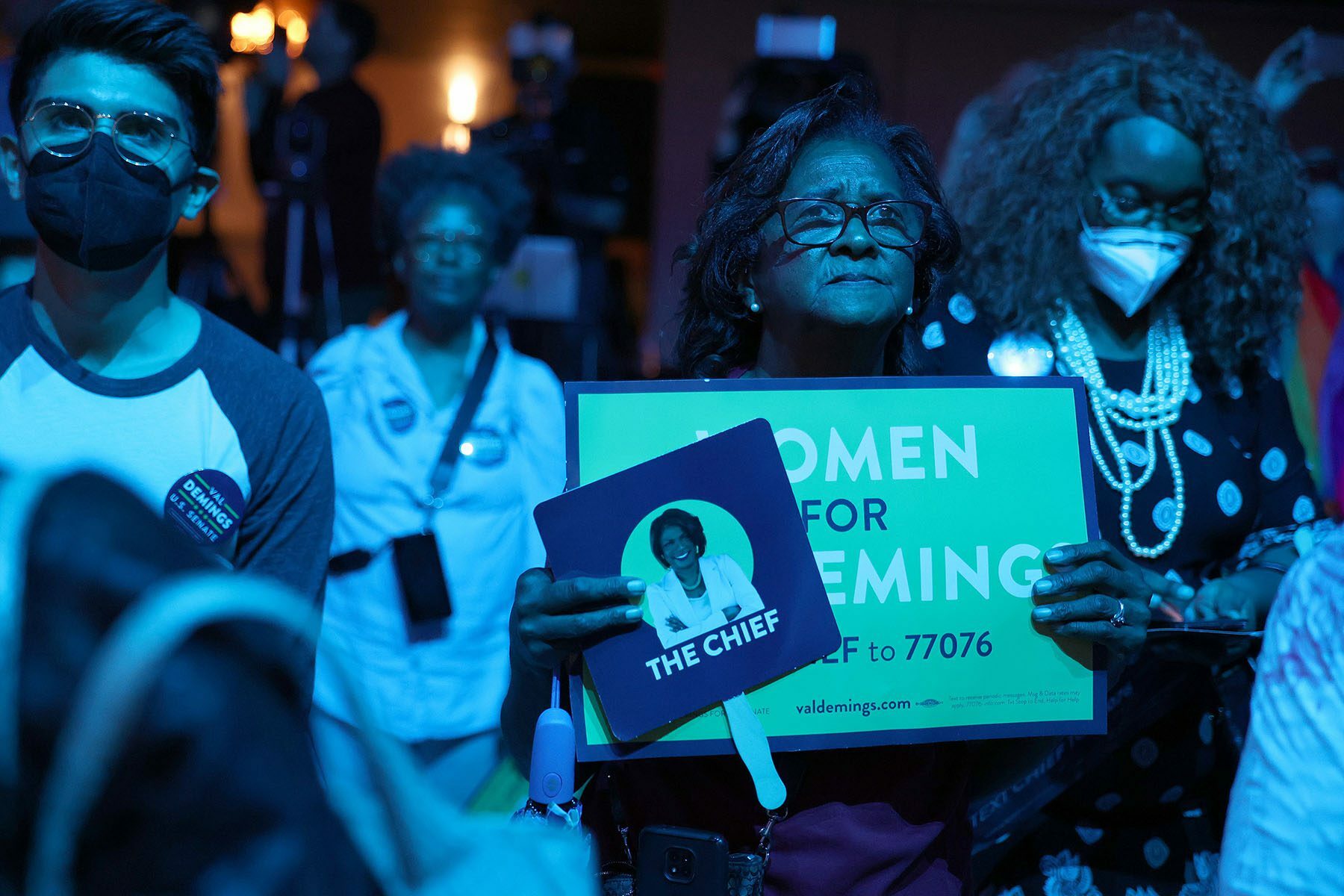 A Demings supporter holds a sign that reads 