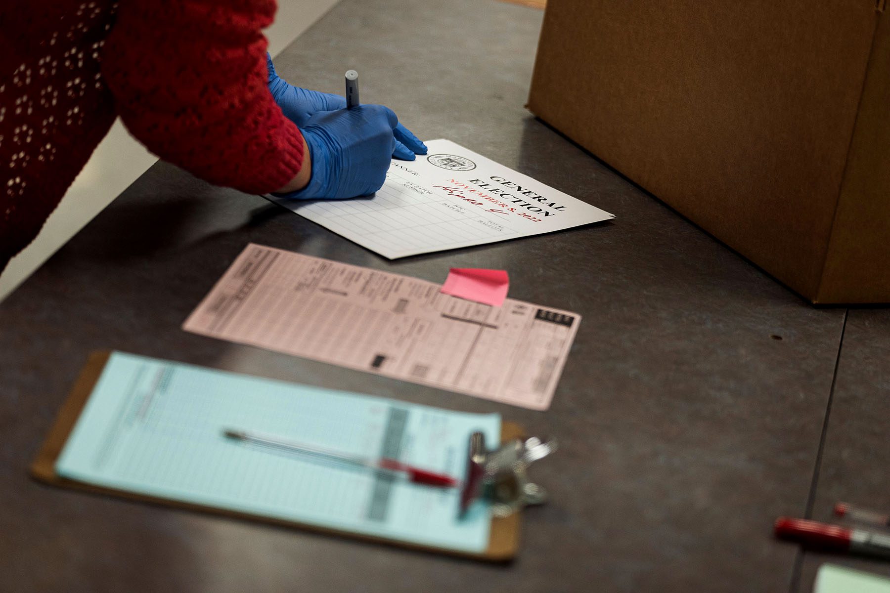 A poll worker handles ballots for the midterm election.