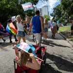 Participants wave flags at the National Trans Visibility March in Orlando, Florida.
