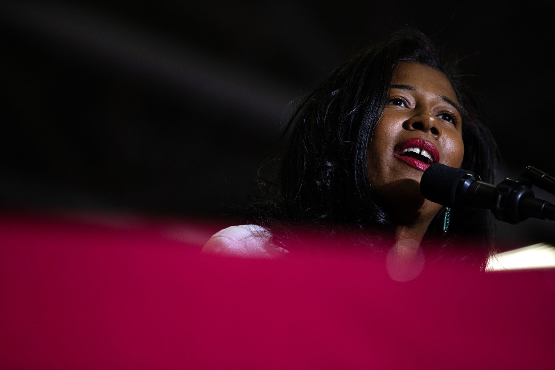 Kristina Karamo speaks into a microphone during a "Save America" rally.